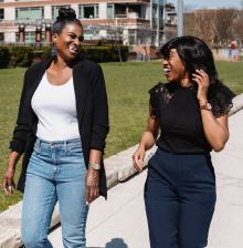 Picture of two smiling women, walking outside
